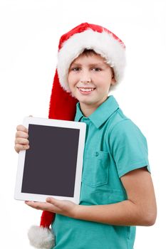 smiling teenage boy with santa claus hat isolated on white and showing his new digital tablet 