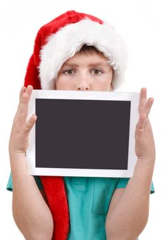 teenage boy with santa claus hat isolated on white and showing his new digital tablet 