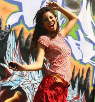 girl listening to music over a colour background 