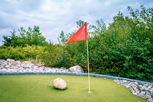 Large minigolf cource with a flag in the hole