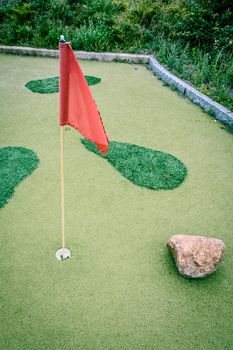 Large minigolf cource with a flag in the hole