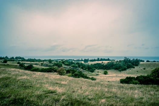 Green fields with cloudy weather and the ocean