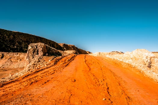 Orange road going through a canyon