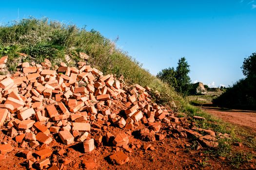 Pile of red bricks in the nature