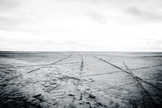 Black and white photograph of low tide beach