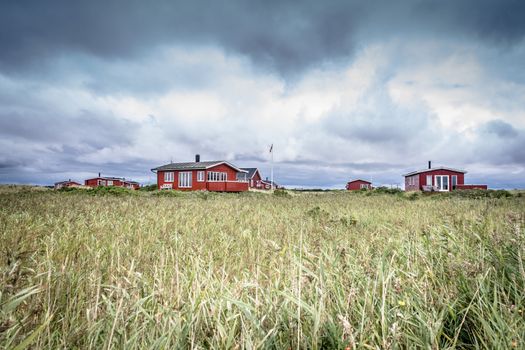 Scandinavian summer cabins in stormy weather