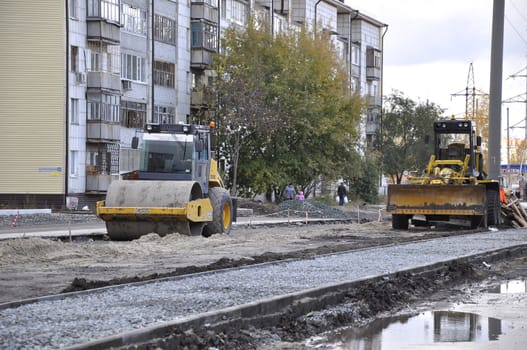 The special equipment on a construction of roads. Skating rink, bulldozer.