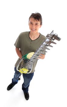 Smiling male teenager holding an electric hedge trimmer.  White background,