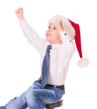 Little happy boy in red santa hat on white background