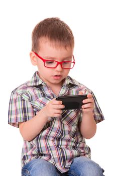 Clever kid is playing with black smart cell phone isolated on white background
