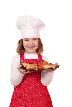 happy little girl cook with chicken drumstick on plate
