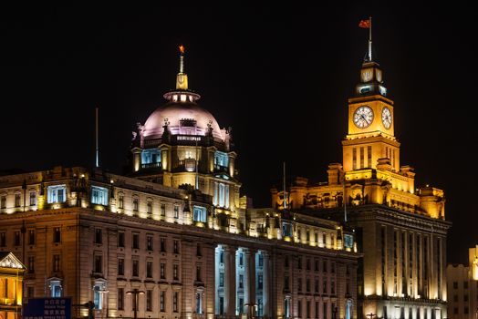Shanghai, China - April 7, 2013: custom house and hsbc building  the bund at night at the city of Shanghai in China on april 7th, 2013