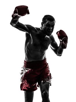 one caucasian man exercising thai boxing in silhouette studio  on white background