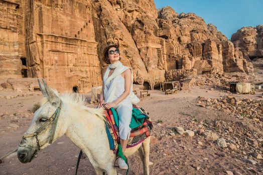 tourist riding donkey in nabatean petra jordan middle east