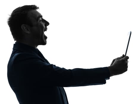 one caucasian business man holding digital tablet  laughing  in silhouette on white background
