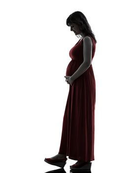 one caucasian pregnant  woman full length in silhouette studio on white background