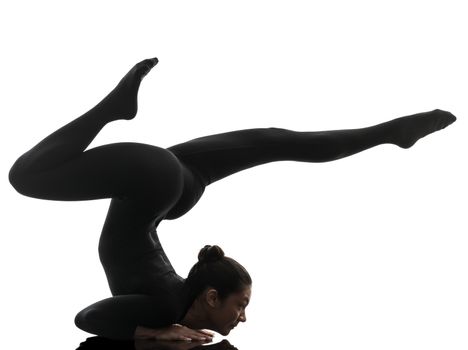 one caucasian woman contortionist practicing gymnastic yoga  in silhouette   on white background