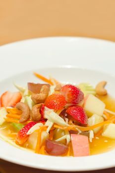 spicy mix  fruits salad ( strawberry, mango, nut, apple, grapes )  , thai style  cuisine