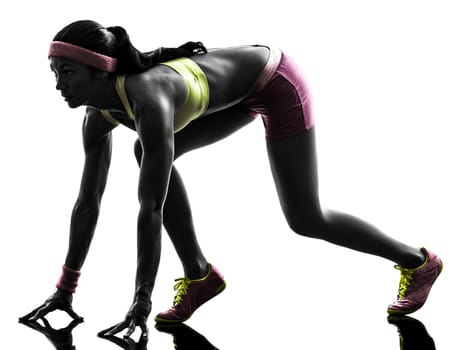 one caucasian woman runner running  on starting blocks  in silhouette on white background