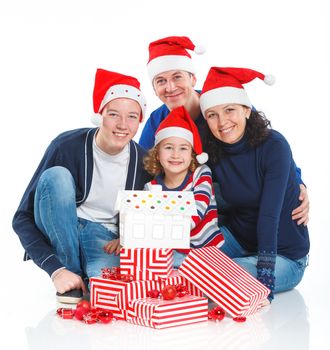 Christmas theme - Portrait of friendly family in Santa's hat with gift box, isolated on white