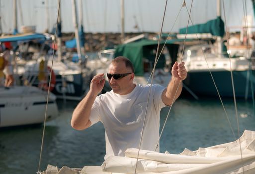 Handsome man on a yacht boat  in summer .