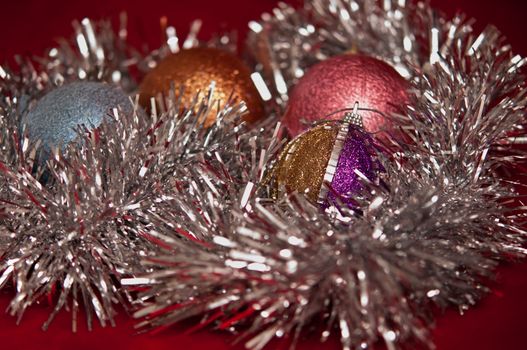 Varicoloured christmas balls on red  background  .