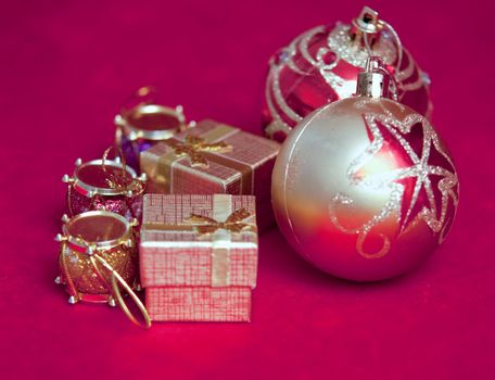 Varicoloured christmas balls on red  background  .