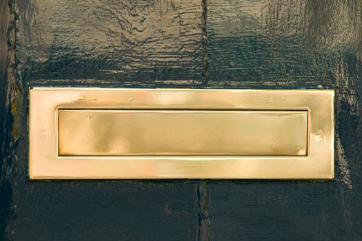 A Brass Mail Slot on a Green Door