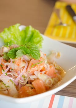 spicy salmon salad with chili and  mixed  vegetable in white bowl 
