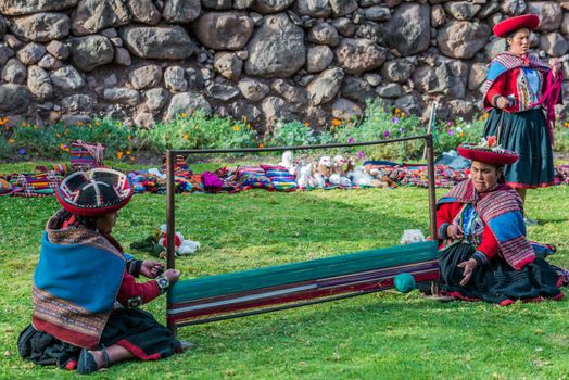 Cuzco, Peru - July 15, 2013: women weaving in the peruvian Andes at Cuzco Peru on july 15th, 2013