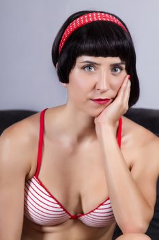 View of a pin-up girl in bikini on the sofa.