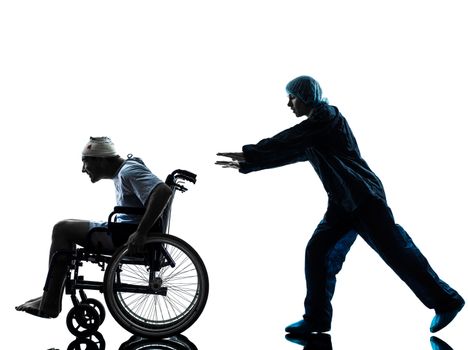 one injured man in wheelchair escaping away of nurse in silhouette studio on white background