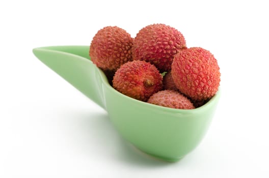 litchies in a bowl isolated on white background 