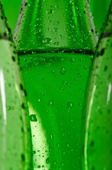Green bottles of mineral water with water drops on it