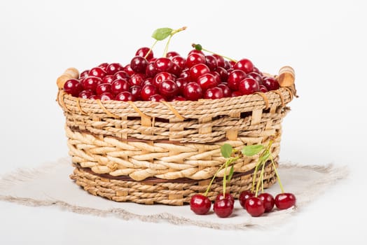Sweet cherry in basket on white background