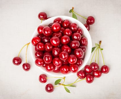 Sweet juicy cherries in a bowl on the napkin