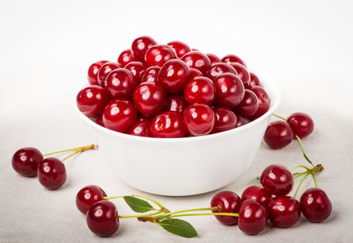 Sweet juicy cherries in a bowl on the napkin