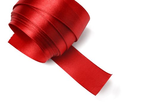 Shiny red satin ribbon on white background