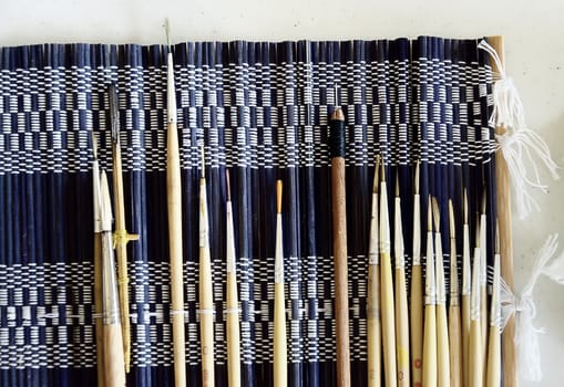 Paintbrush set on fabric background
