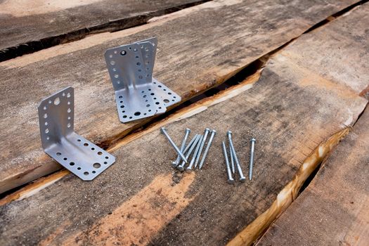 Fasteners: Metal screws and corners against the wooden roof decking