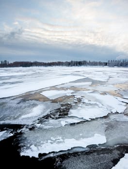 Thin ice on the lake and sunrise