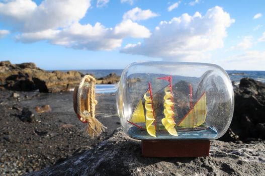 Ancient Spanish Sailing Boat in a Bottle near the Ocean