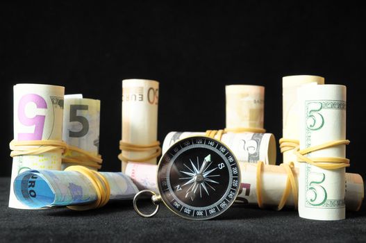 Orientation in  Business Compass and Money on a Black Background