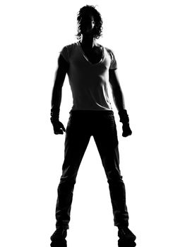 full length silhouette of a young man dancer dancing standing funky hip hop r&b on  isolated  studio white background