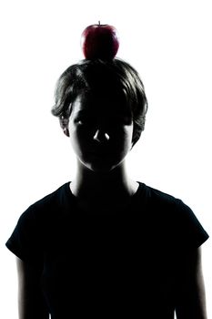 one caucasian young teenager silhouette boy or girl with an apple on his head portrait in studio cut out isolated on white background