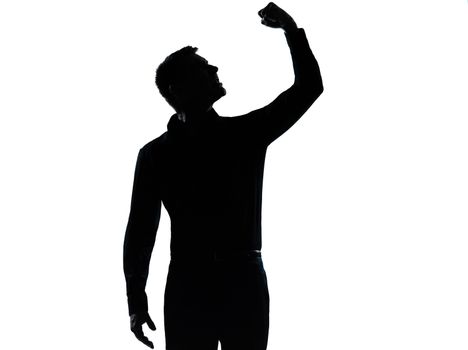 one caucasian business man angry fisting up  silhouette standing Full length in studio isolated on white background