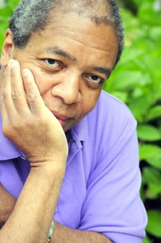 African American male posing outside.