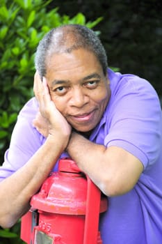 African American male posing outside.