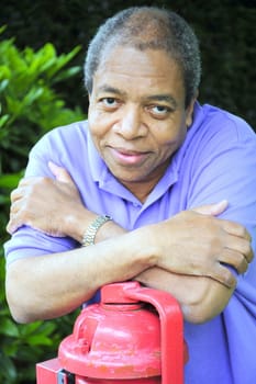 African American male posing outside.