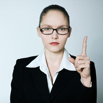 studio shot portrait of one caucasian young  teacher nanny business woman pointing up finger